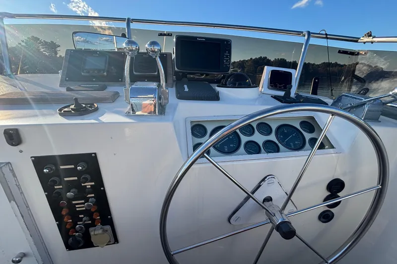 Slide: The Image of Helm of 1989 Grand Banks 46 Classic yacht with navigation instruments and steering wheel. - 53