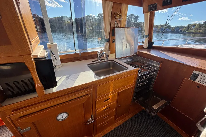 Slide: The Image of Interior of 1989 Grand Banks 46 Classic yacht with kitchen and scenic water view. - 61