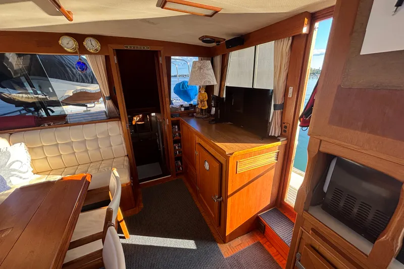 Slide: The Image of Interior of 1989 Grand Banks 46 Classic yacht with wood furnishings and seating area. - 62