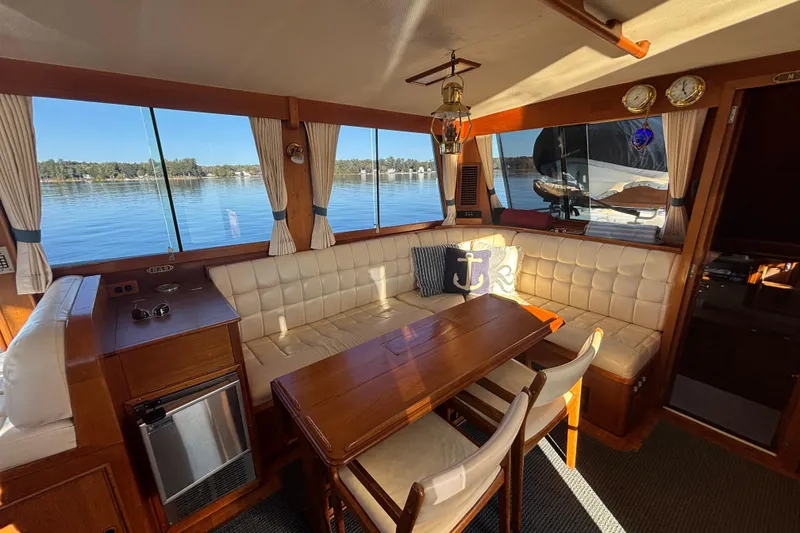 Slide: The Image of Interior of 1989 Grand Banks 46 Classic yacht with elegant seating and wooden table. - 63