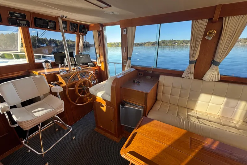 Slide: The Image of Interior of 1989 Grand Banks 46 Classic yacht with helm, seating, and scenic water view. - 64