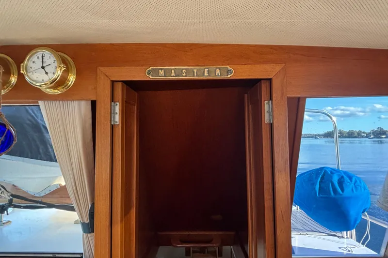 Slide: The Image of Interior view of 1989 Grand Banks 46 Classic yacht with wooden door labeled "Master." - 66