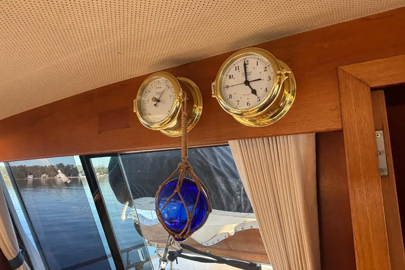 Slide: The Image of Interior of 1989 Grand Banks 46 Classic with brass clock, barometer, and nautical decor. - 67