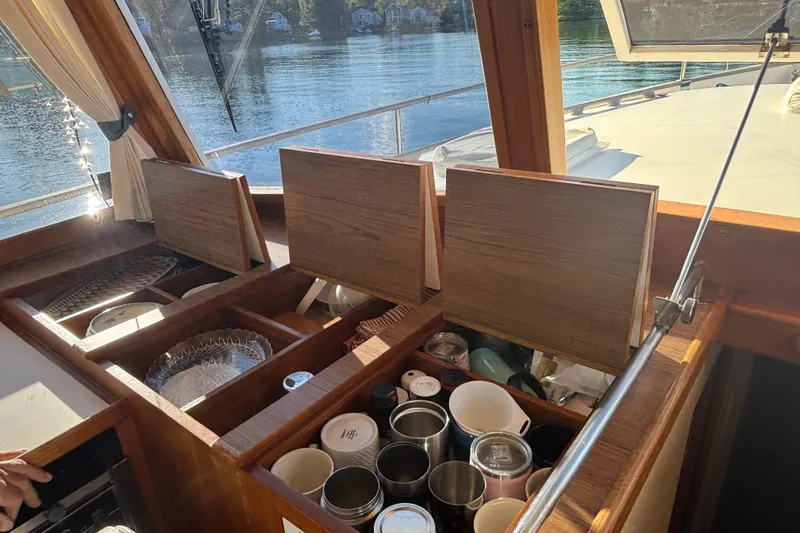 Slide: The Image of Interior of 1989 Grand Banks 46 Classic yacht with open wooden storage compartments. - 71