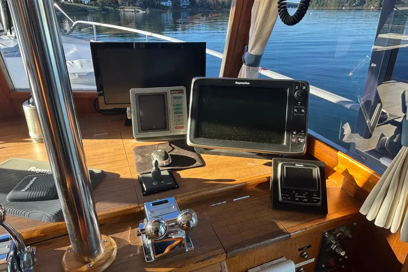 Slide: The Image of Helm of 1989 Grand Banks 46 Classic with navigation equipment and scenic water view. - 76