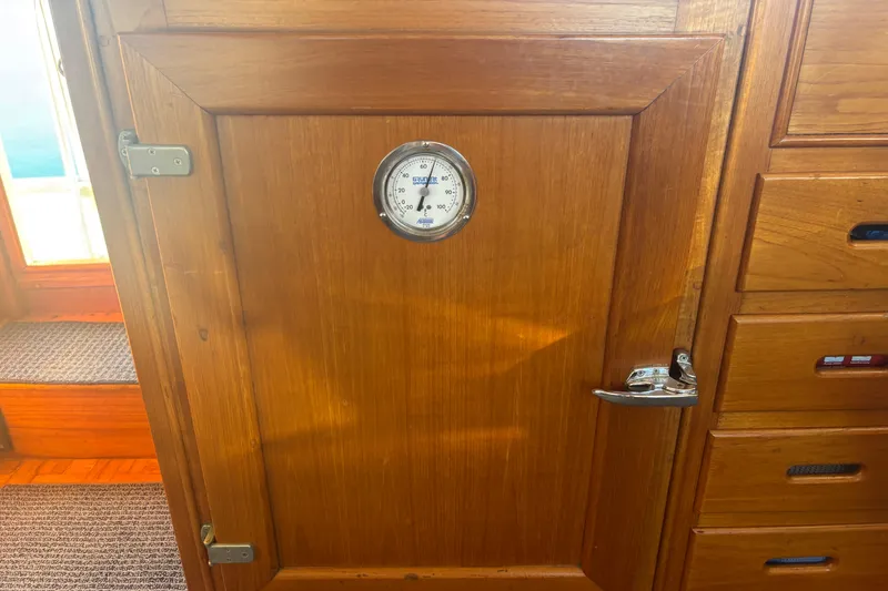 Slide: The Image of Wooden interior of 1989 Grand Banks 46 Classic with thermometer on cabinet door. - 85