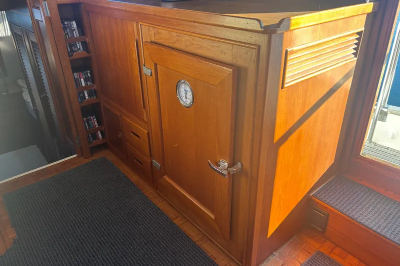 Slide: The Image of Wooden interior of 1989 Grand Banks 46 Classic yacht with storage and thermometer. - 89