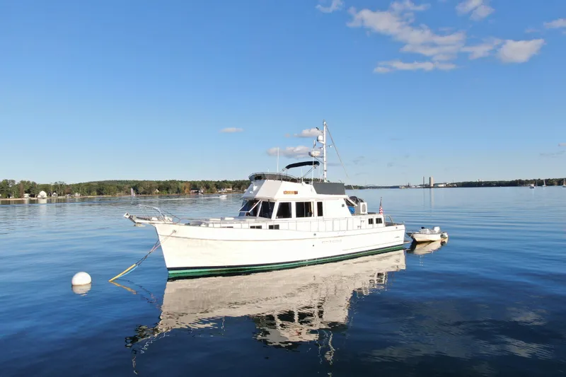 Slide: The Image of 1989 Grand Banks 46 Classic yacht on calm water under clear blue sky. - 9