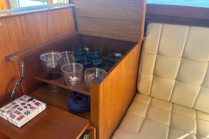 Slide: The Image of Wooden cabinet with glassware and napkins on a 1989 Grand Banks 46 Classic yacht. - 94