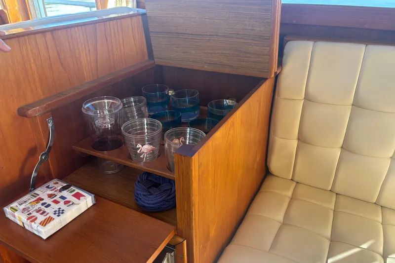 Slide: The Image of Interior of 1989 Grand Banks 46 Classic with wooden cabinet and glassware storage. - 95
