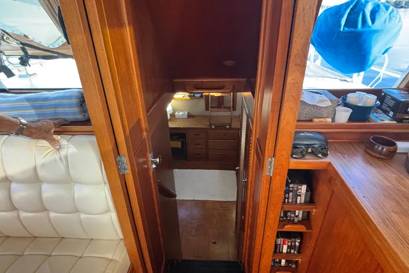 Slide: The Image of Interior view of 1989 Grand Banks 46 Classic yacht, featuring wood cabinetry and seating. - 99