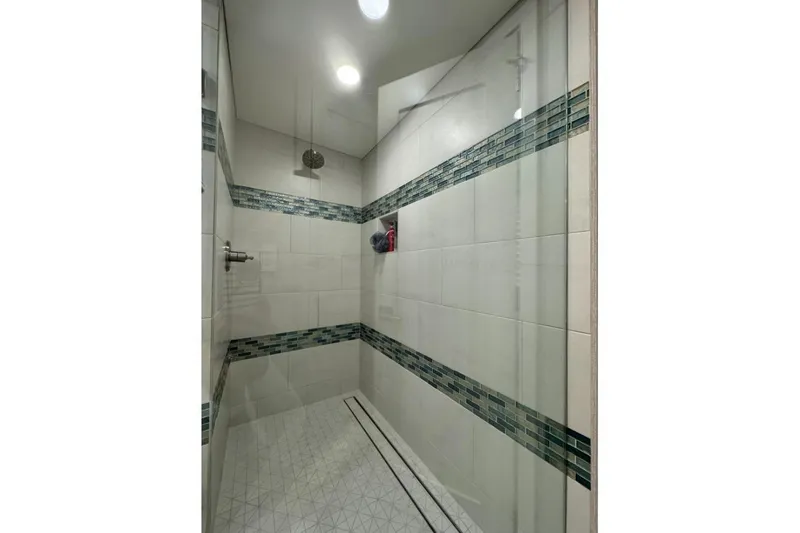 Slide: The Image of Modern shower with glass door, tiled walls, and recessed lighting in Adonia Layin' Low 2022 model. - 12