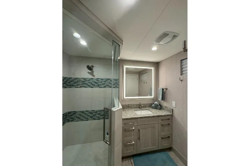 Slide: The Image of Modern bathroom in 2022 Adonia Layin' Low with glass shower and granite countertop. - 19