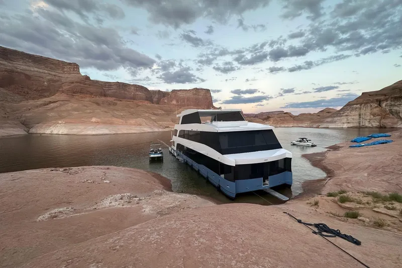 Slide: The Image of Houseboat "Adonia Layin' Low" 2022 docked in scenic canyon lake setting. - 2