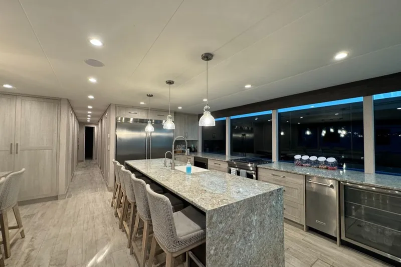 Slide: The Image of Luxurious modern kitchen in 2022 Adonia Layin' Low houseboat with sleek design and ample lighting. - 21