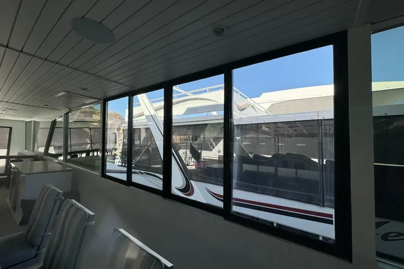 Slide: The Image of Interior view of 2022 Adonia Layin' Low boat, featuring large windows and seating area. - 28