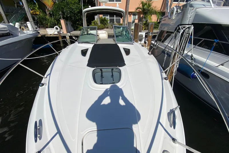 Slide: The Image of 2012 Sea Ray 330 Sundancer docked, showcasing sleek design and spacious deck. - 10