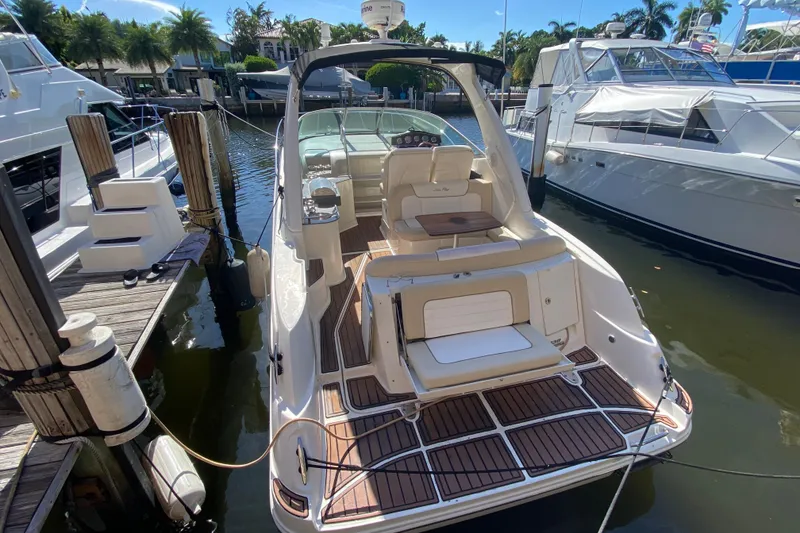 Slide: The Image of 2012 Sea Ray 330 Sundancer docked, featuring spacious deck and luxurious seating. - 17