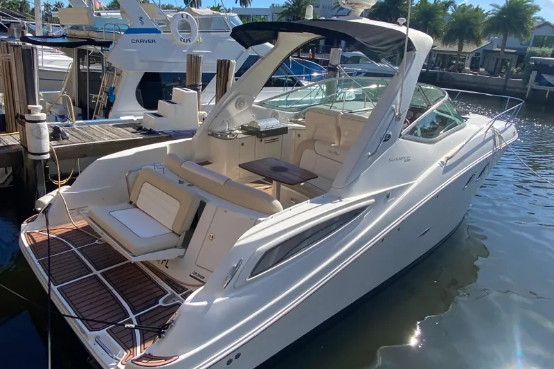 Slide: The Image of 2012 Sea Ray 330 Sundancer yacht docked at marina, featuring sleek design and spacious deck. - 19