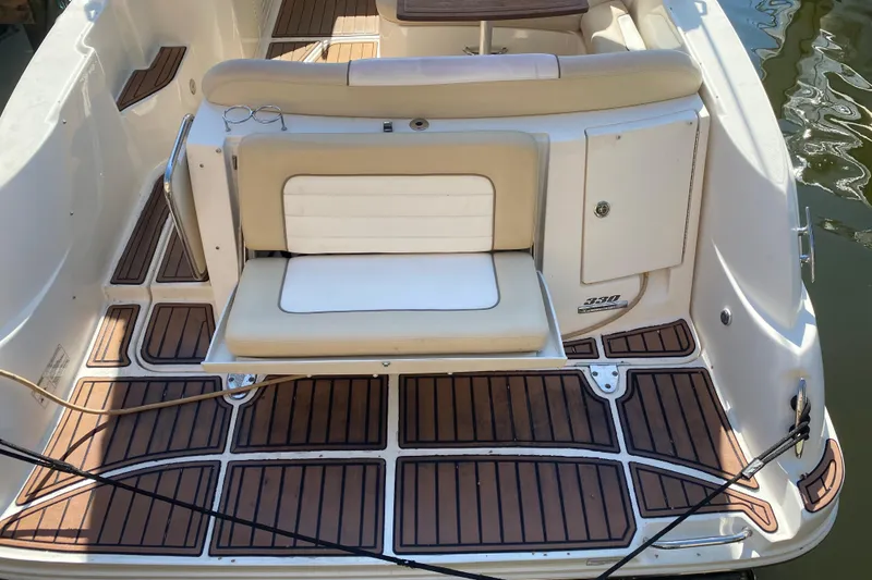 Slide: The Image of 2012 Sea Ray 330 Sundancer boat deck with cushioned seating and wood-patterned flooring. - 20