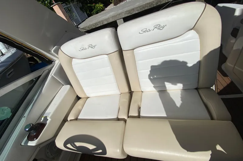 Slide: The Image of 2012 Sea Ray 330 Sundancer boat seats with beige and white upholstery. - 23