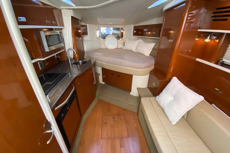 Slide: The Image of Interior of 2012 Sea Ray 330 Sundancer yacht with kitchen and cozy sleeping area. - 27