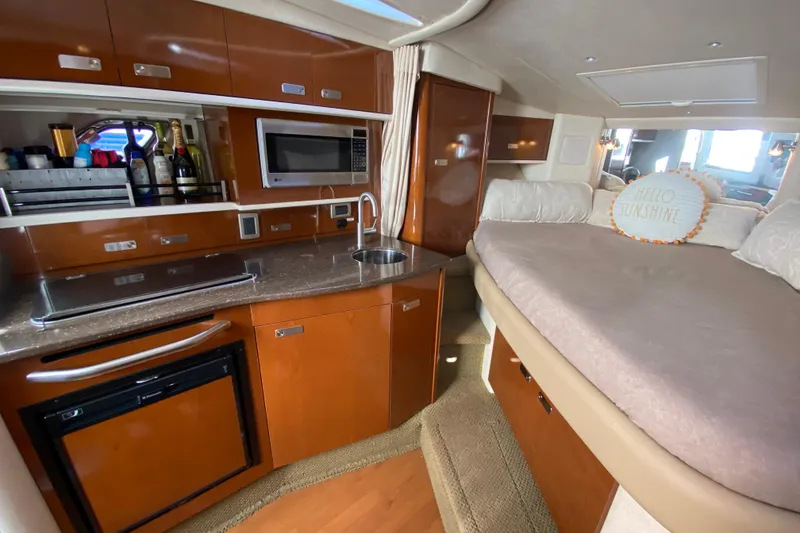 Slide: The Image of Interior of 2012 Sea Ray 330 Sundancer with kitchenette and cozy sleeping area. - 29