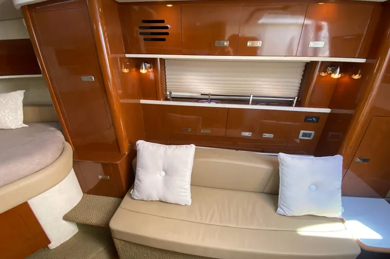 Slide: The Image of Luxurious interior of 2012 Sea Ray 330 Sundancer with beige seating and wooden cabinetry. - 33