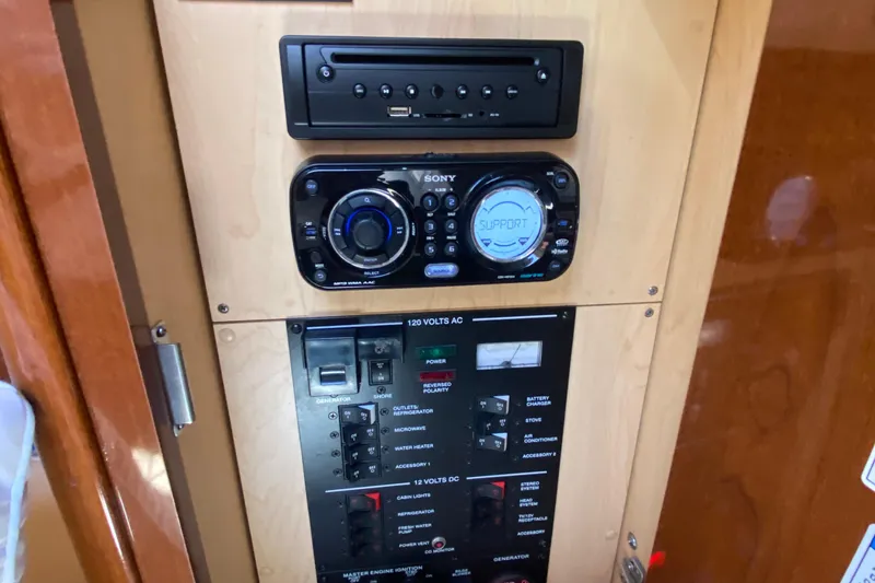 Slide: The Image of Control panel of a 2012 Sea Ray 330 Sundancer boat with audio system and switches. - 34