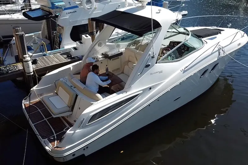 Slide: The Image of 2012 Sea Ray 330 Sundancer yacht docked with two people onboard. - 37