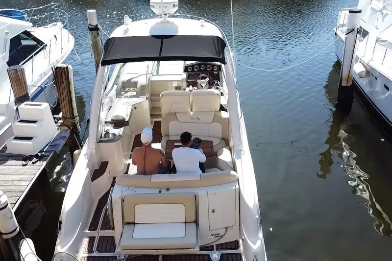 Slide: The Image of 2012 Sea Ray 330 Sundancer docked with passengers enjoying the view. - 38