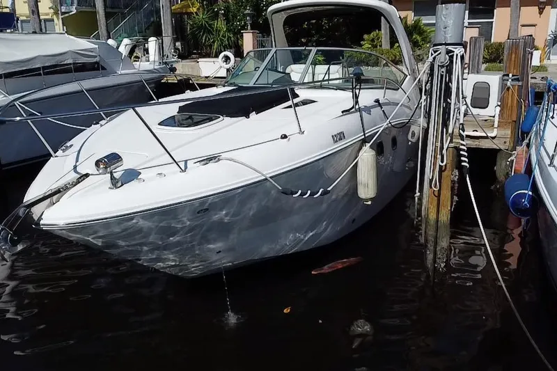 Slide: The Image of 2012 Sea Ray 330 Sundancer docked at marina, sleek design, white exterior. - 6