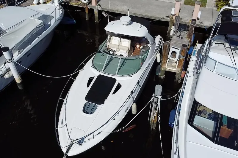 Slide: The Image of 2012 Sea Ray 330 Sundancer yacht docked between two boats. - 7