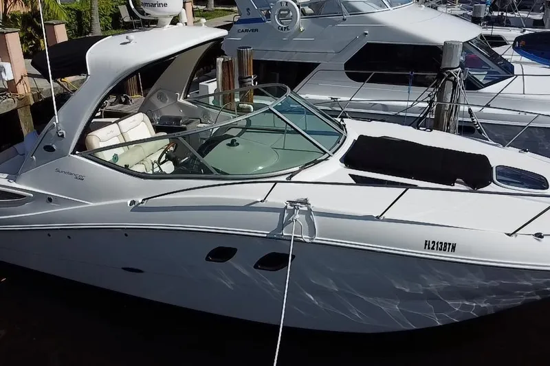 Slide: The Image of 2012 Sea Ray 330 Sundancer yacht docked at marina, featuring sleek design and spacious cockpit. - 9