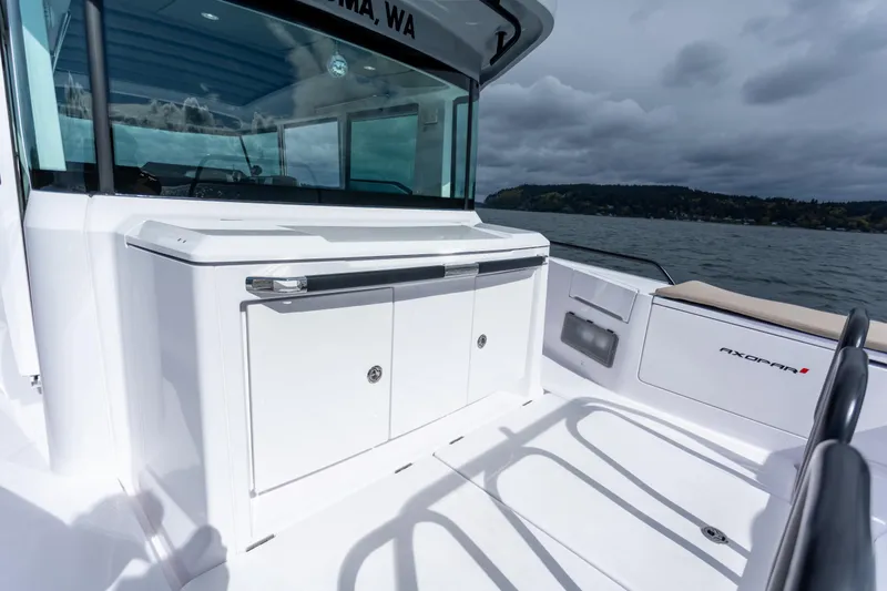 Slide: The Image of 2022 Axopar 37 XC Cross Cabin boat deck with sleek design and storage compartments. - 24
