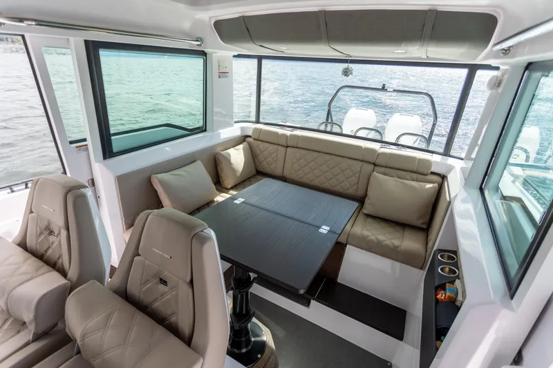 Slide: The Image of Luxurious interior of 2022 Axopar 37 XC Cross Cabin with seating and table. - 28