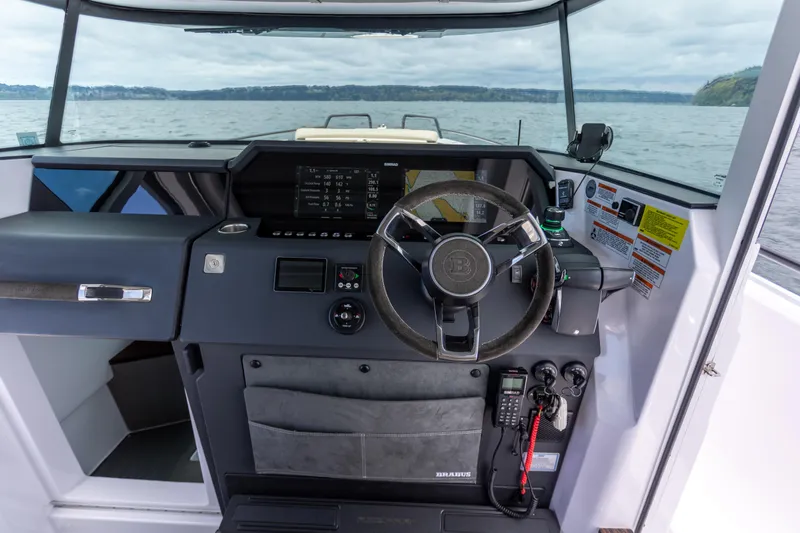 Slide: The Image of Cockpit of 2022 Axopar 37 XC Cross Cabin with modern navigation controls and steering wheel. - 32