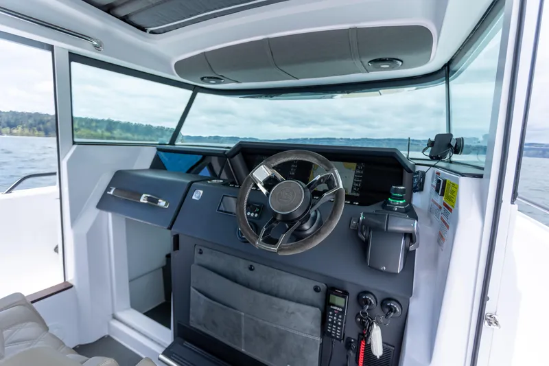 Slide: The Image of Interior view of 2022 Axopar 37 XC Cross Cabin helm with modern controls and steering wheel. - 34