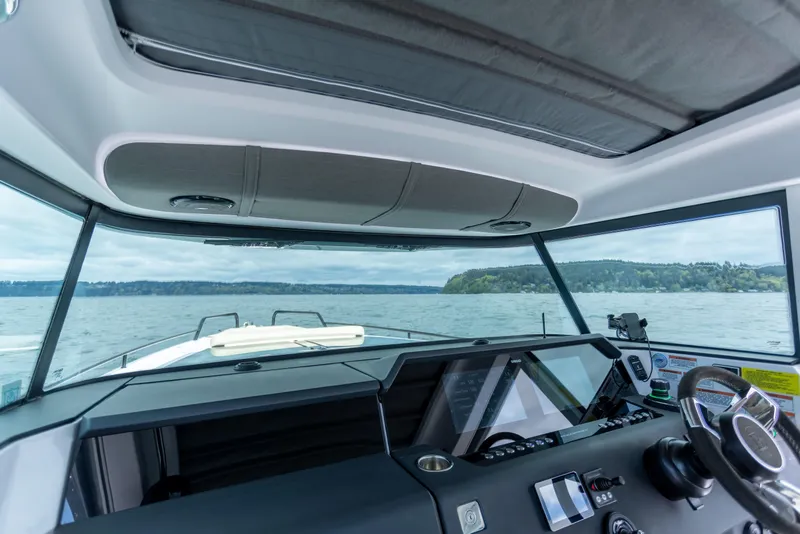 Slide: The Image of Interior view of 2022 Axopar 37 XC Cross Cabin, showcasing dashboard and panoramic windows. - 35