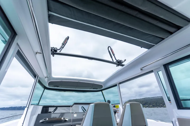 Slide: The Image of Interior view of 2022 Axopar 37 XC Cross Cabin with open sunroof and modern seating. - 37