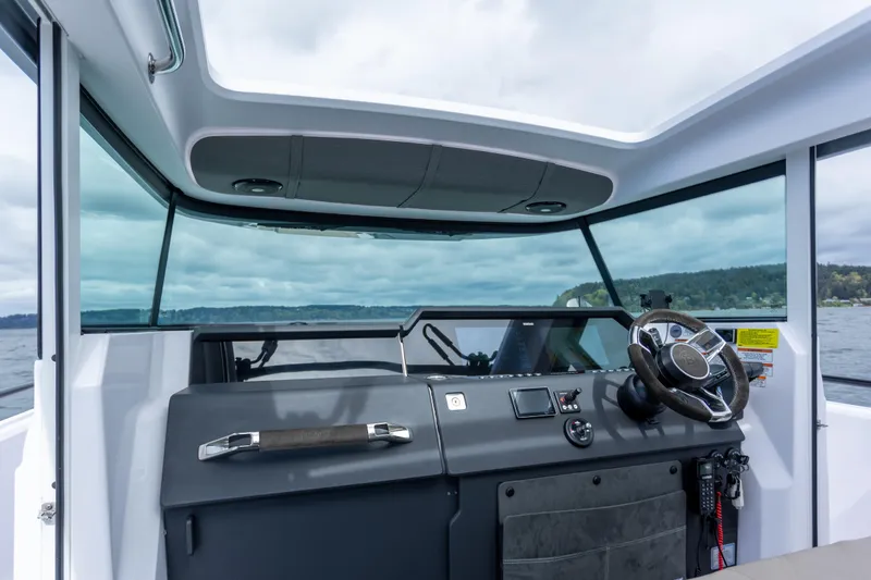 Slide: The Image of Interior view of 2022 Axopar 37 XC Cross Cabin boat cockpit with steering wheel. - 39
