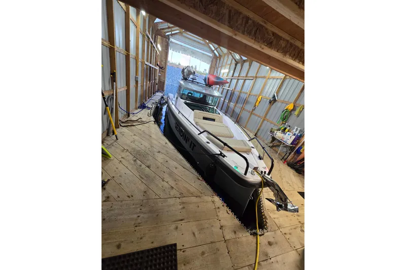 Slide: The Image of 2022 Axopar 37 XC Cross Cabin boat docked in a wooden boathouse. - 40