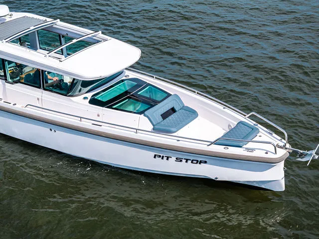 Slide: The Image of 2022 Axopar 37 XC Cross Cabin boat named "Sendin' It" on open water. - 6