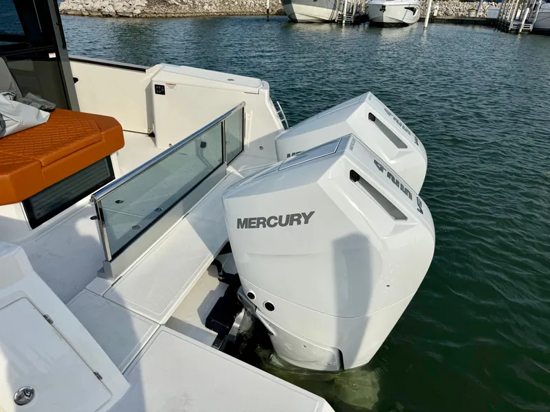 Slide: The Image of Two Mercury outboard engines on a Saxdor 400 GTC boat in the water. - 39