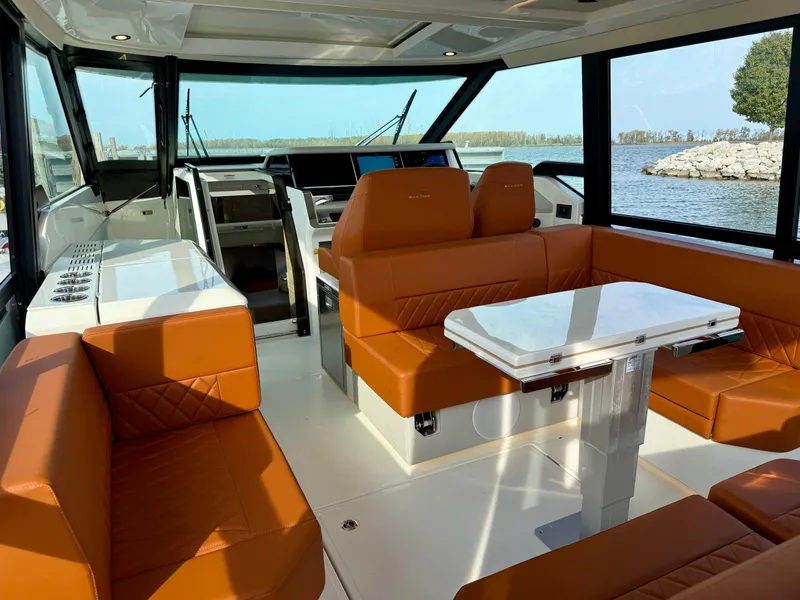 Slide: The Image of Interior of a Saxdor 400 GTC with brown leather seating and a white table. - 12