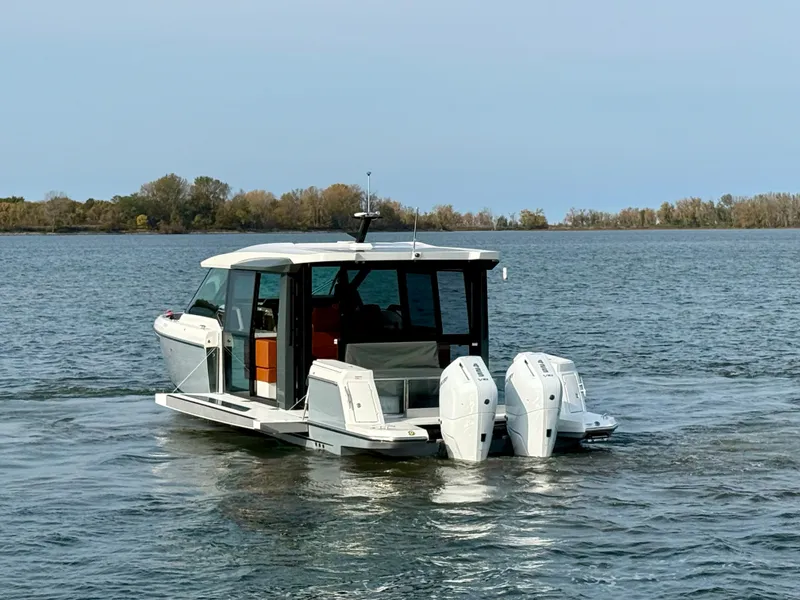 Slide: The Image of A 2027 Saxdor 400 GTC boat with twin outboard engines on calm waters. - 3