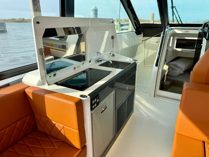 Slide: The Image of Interior of the Saxdor 400 GTC featuring a modern kitchen and orange seating. - 20