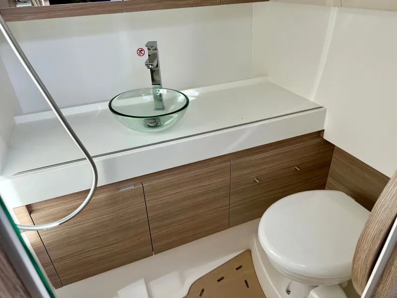 Slide: The Image of Modern bathroom with glass sink and wooden cabinets on a boat. - 33
