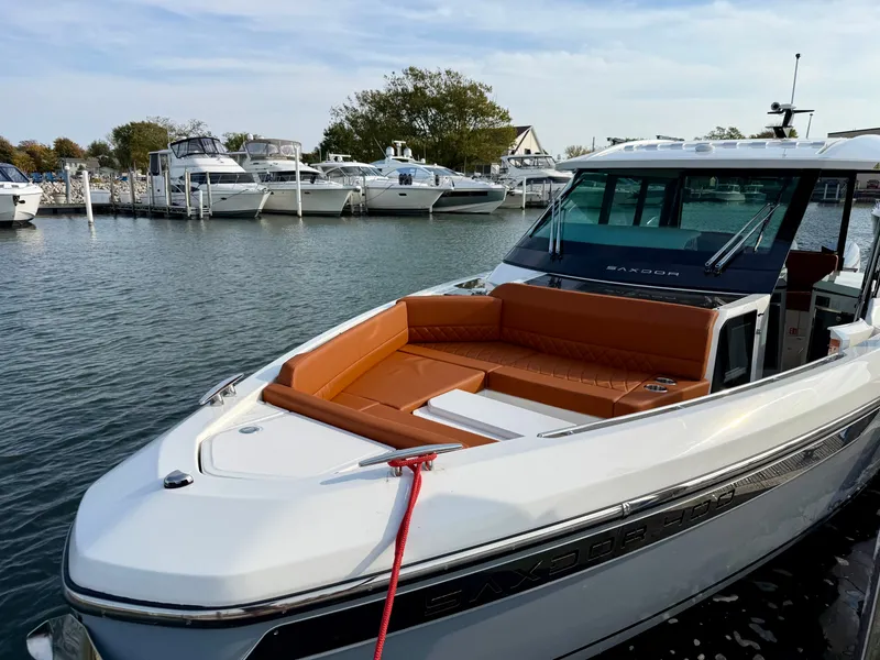 Slide: The Image of The image shows a 2027 Saxdor 400 GTC boat with sleek, modern design docked at a marina. - 28