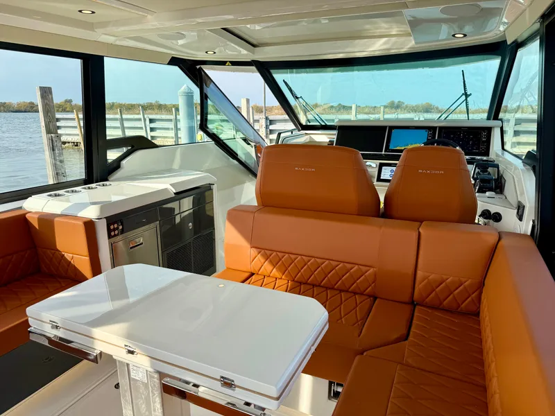Slide: The Image of Interior of the Saxdor 400 GTC with brown leather seating and a white table. - 22